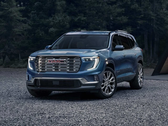 Blue 2026 GMC Acadia on a gravel road